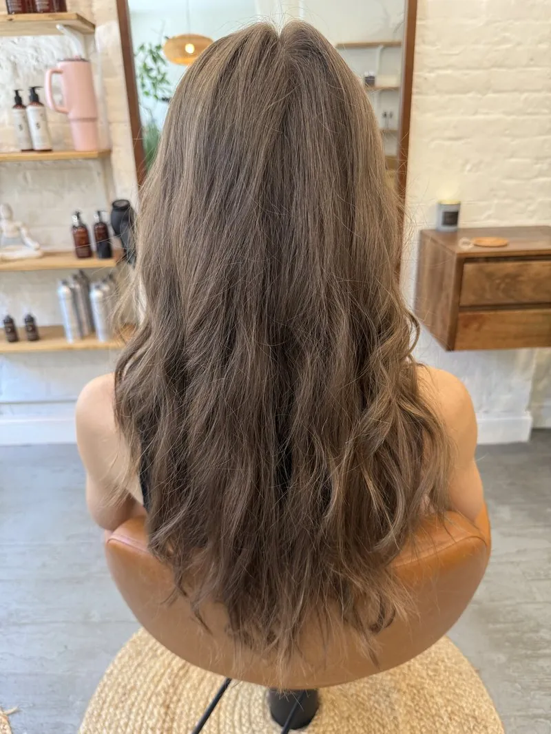 Long flat brunette hair before a balayage and highlighting service