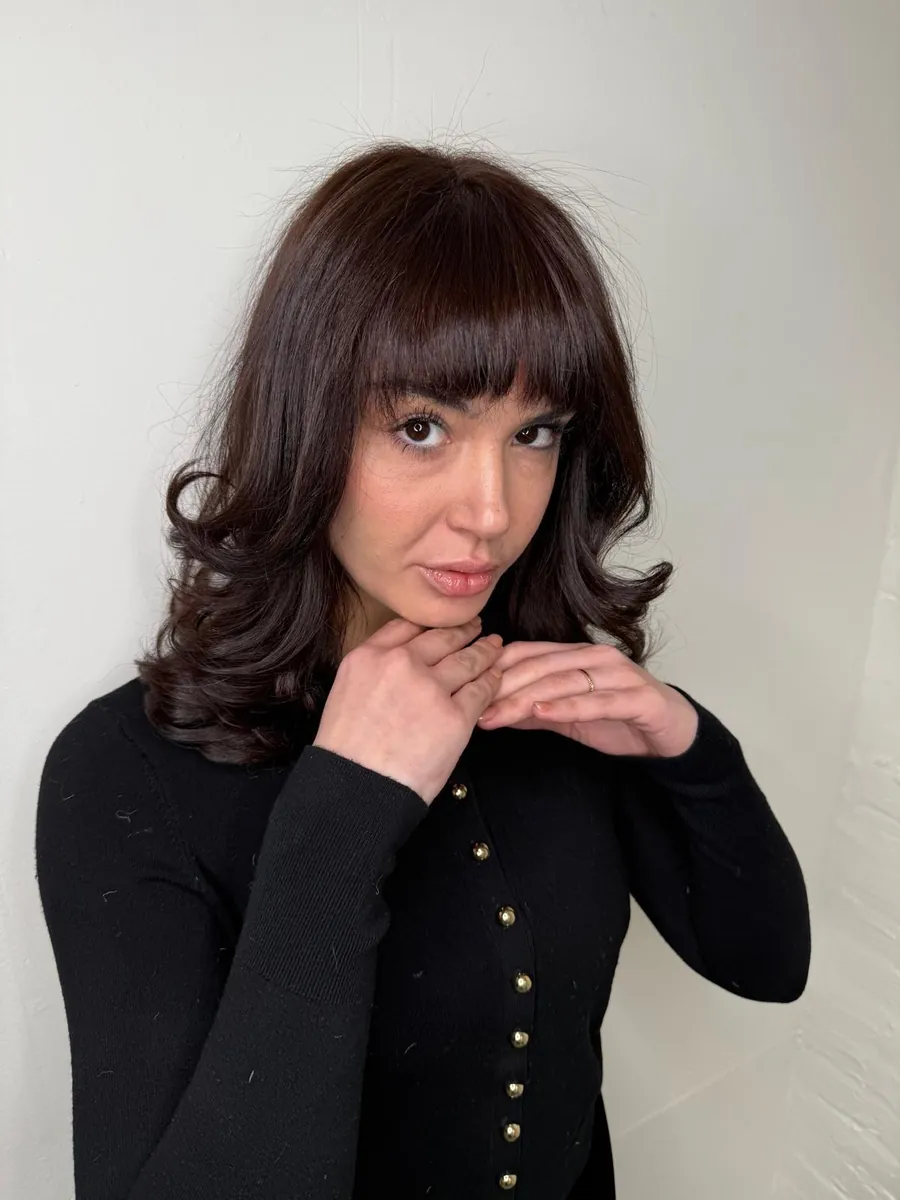 Rich red bob with a full fringe after color and cut