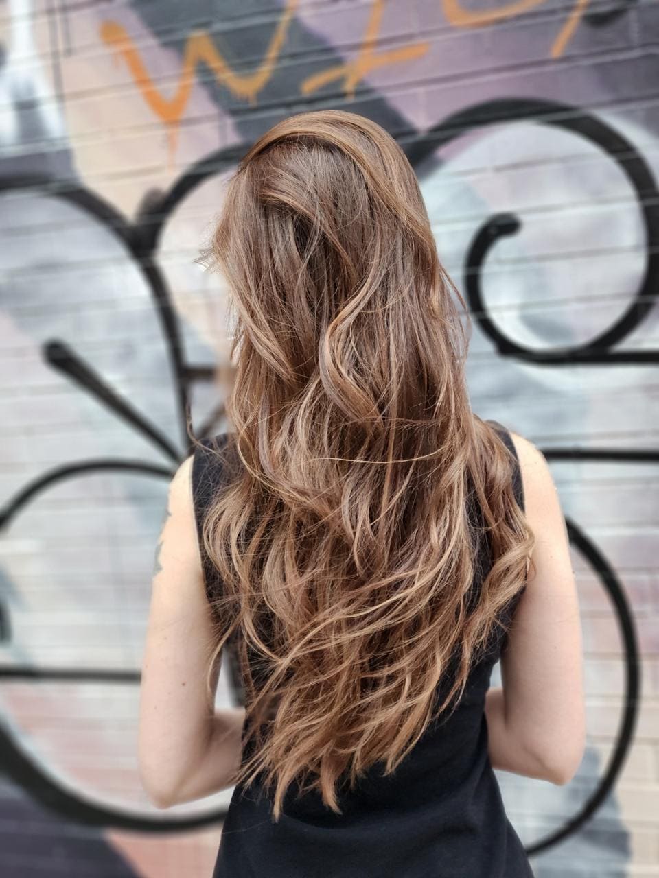 Back view of long layered waves in caramel dimensional color, Williamsburg Salon